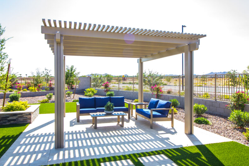 rear patio pergola with wooden furniture